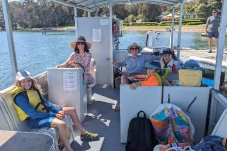 a group of people sitting on a boat
