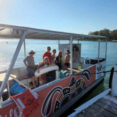 a group of people in a boat on a body of water