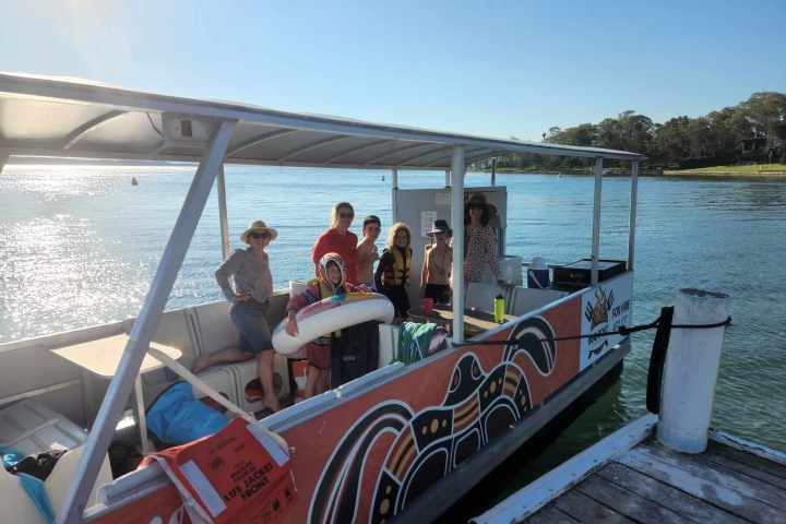 a group of people in a boat on a body of water