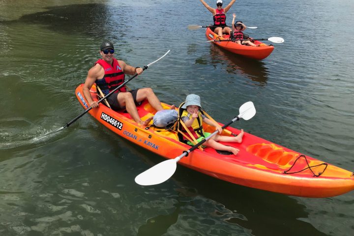 a group of people in a small boat in a body of water
