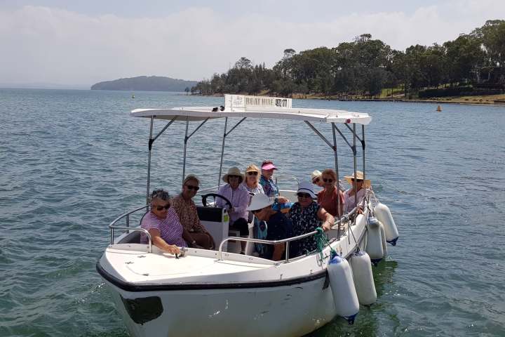 a group of people in a small boat in a body of water