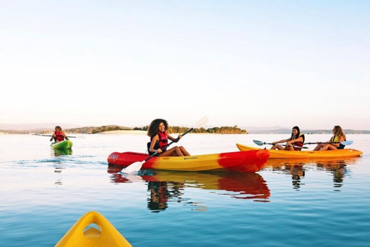 a group of people sitting on a boat in the water