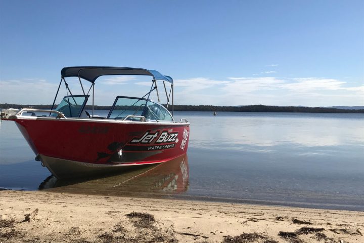 a boat sitting on top of a sandy beach