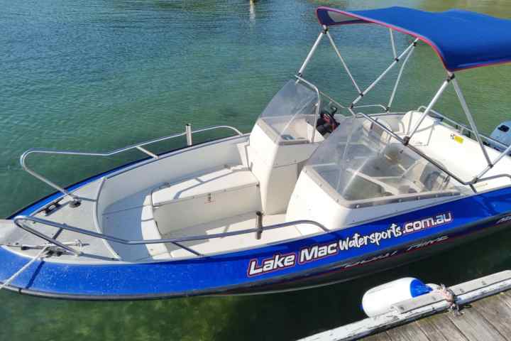 a boat that is sitting on a blue surface