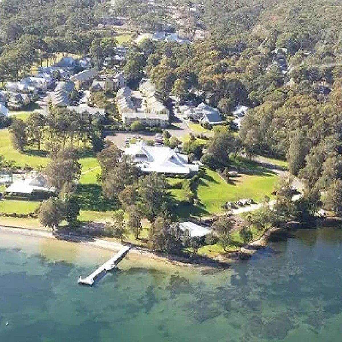 a close up of a hillside next to water